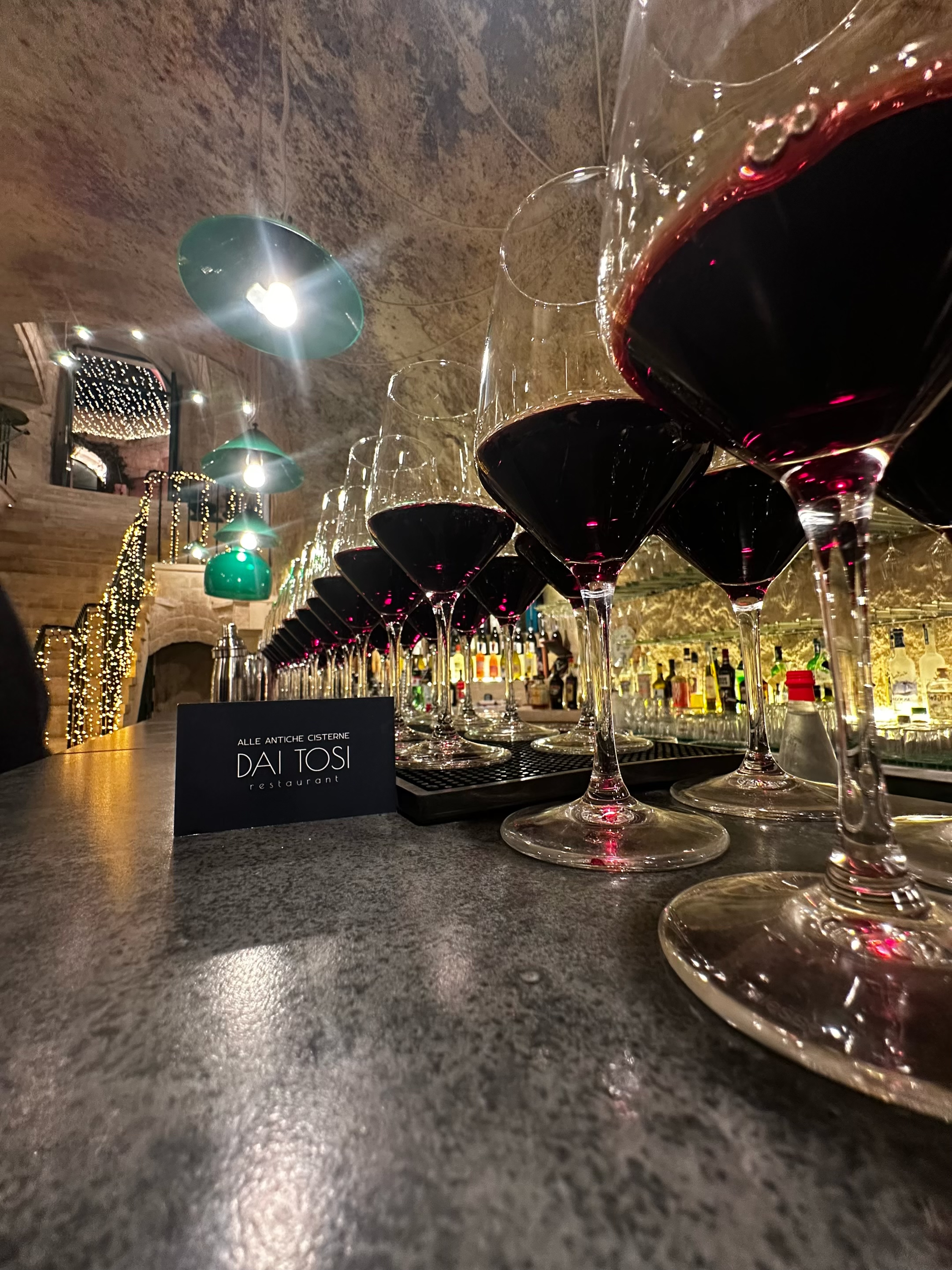 Calici di vino rosso al banco bar delle Antiche Cisterne